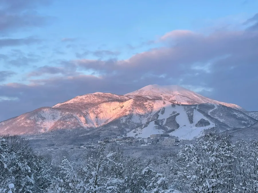 Mt Annupuri at dawn in winter, snow-covered ski runs above the Hirafu base area, Niseko