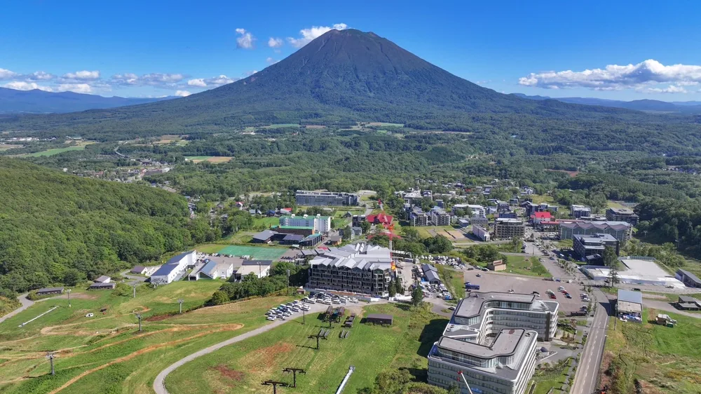 Aerial view of the Hirafu resort village in summer with Mt Yotei behind, Kutchan, Hokkaido